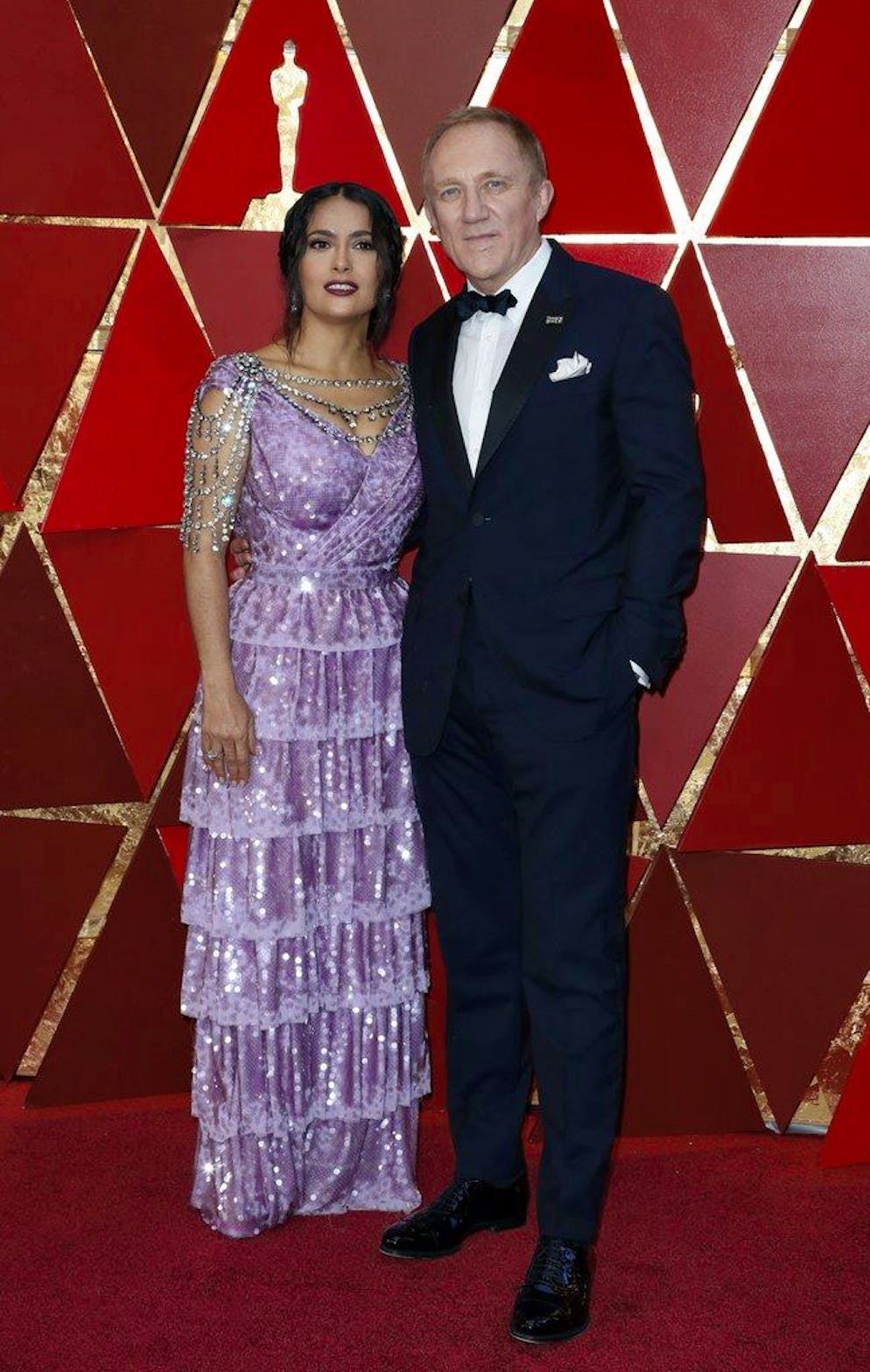 Le tapis rouge des Oscars. Salma Hayek, vêtue d'une robe mauve pâle, brillait de mille paillettes au bras de son mari François-Henri Pinault.
