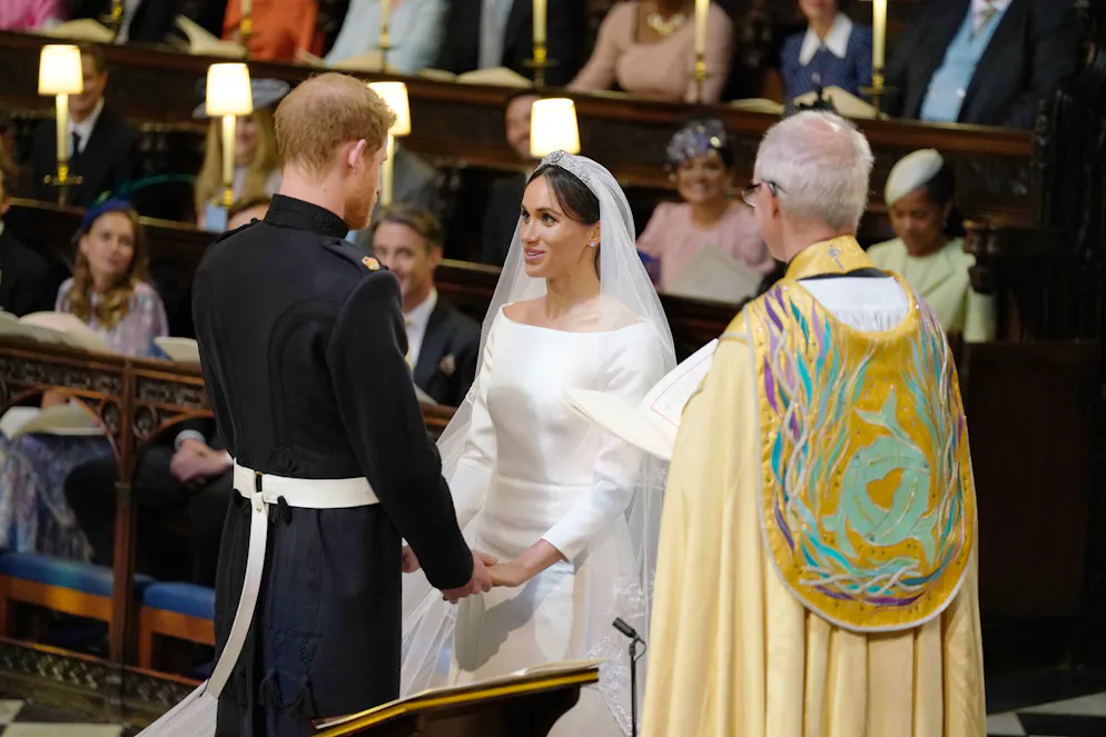 Britain's Prince Harry, Duke of Sussex, and US fiancee of Britain's Prince Harry Meghan Markle during their wedding ceremony in St George's Chapel, Windsor Castle, in Windsor, on May 19, 2018. / AFP PHOTO / POOL / Dominic Lipinski