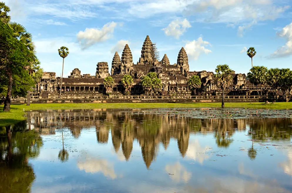 Angor Wat temple in Siem Reap, Cambodia.  Lake reflection with blue sky and clouds.