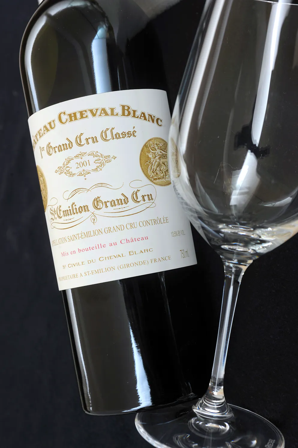 A picture taken on June 16, 2011 shows a 2001 Saint-Emilion Premier Grand Cru Classe A Chateau Cheval Blanc bottle in Saint-Emilion on June 16, 2011, three days ahead of the Vinexpo wine forum in Bordeaux. AFP PHOTO JEAN PIERRE MULLER.