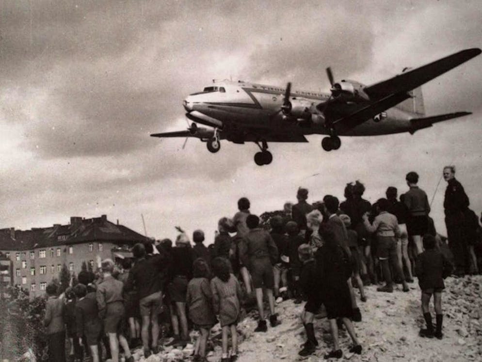 Blocco di Berlino: 70 anni fa, i «Rosinenbomber» sorvolavano la città. Questa immagine, della quale non si conosce la data esatta, mostra un aereo da trasporto Douglas C-54 del pilota americano Gail Halvorsen al suo arrivo a Berlino. L'aviatore, che durante i propri voli aveva l'abitudine di paracadutare con dei fazzoletti dei dolcetti, era soprannominato «bombardiere a caramelle».