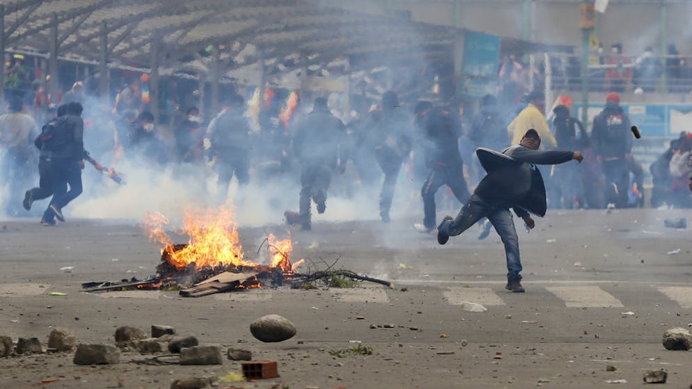 Anhänger des gestürzten bolivianischen Präsidenten Evo Morales werfen in der Hauptstadt La Paz Steine auf Polizisten.