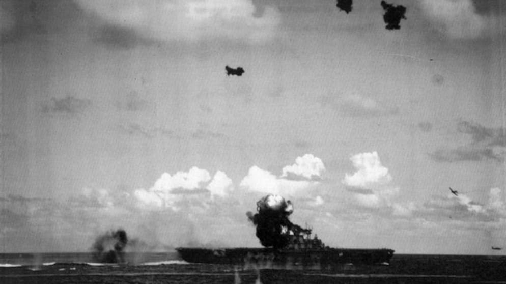 Der Untergang der USS Hornet. ... Hier schlägte eine Aichi D3A – Codename «Val» – auf dem Deck der Hornet ein. Die Zeit vor Ort: 9.14 Uhr. Im Hintergrund nähern bereits die nächsten beiden Torpedobomber vom Typ Nakajima B5N – Codename «Kate» – mit ihrer tödlichen Fracht an.