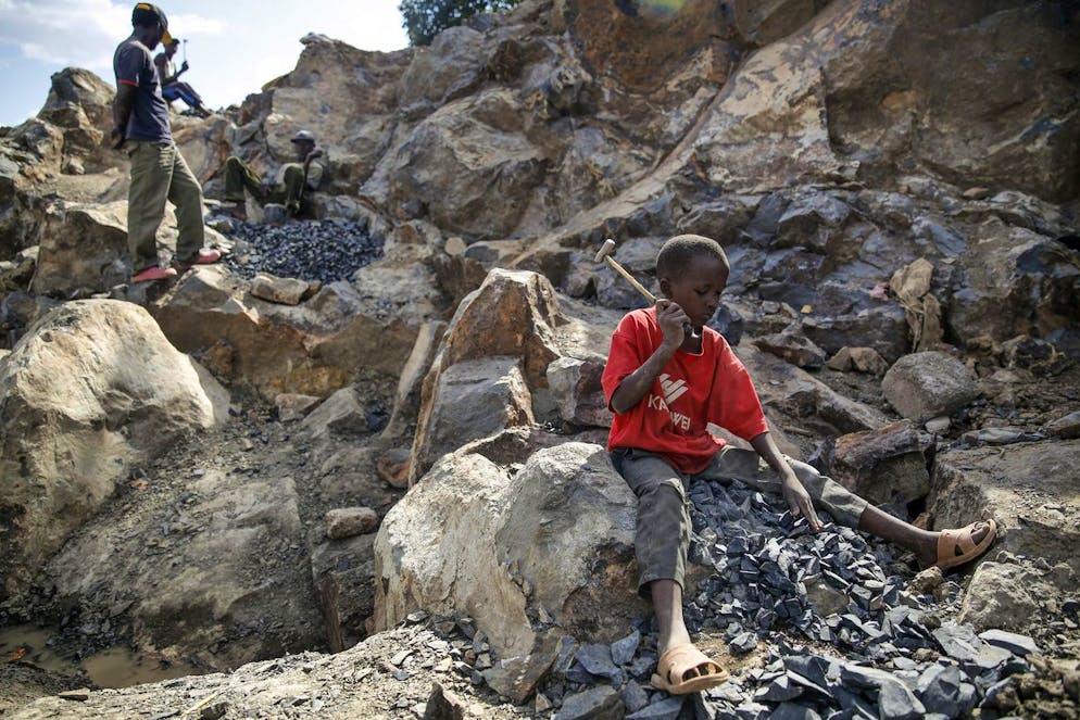 Kevin Mutinda, 7, works breaking rocks with a hammer along with his older sisters and mother, who says she was left without a choice after she lost her cleaning job at a private school when coronavirus pandemic restrictions were imposed, at Kayole quarry in Nairobi, Kenya Tuesday, Sept. 29, 2020. The United Nations says the COVID-19 pandemic risks significantly reducing gains made in the fight against child labor, putting millions of children at risk of being forced into exploitative and hazardous jobs, and school closures could exacerbate the problem. (AP Photo/Brian Inganga)