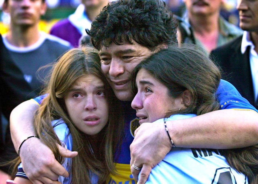 epa08841592 (FILE) - Argentinian soccer legend Diego Armando Maradona (C) embraces his daughters Dalma Nerea (L) and Gianinna Dinora (R) during a tribute match held in his honour at Boca Juniors Stadium in Buenos Aires, Argentina, 10 November 2001 (re-issued on 25 November 2020). Diego Maradona has died after a heart attack, media reports claimed on 25 November 2020. EPA/HARRY HU *** Local Caption *** 00174795