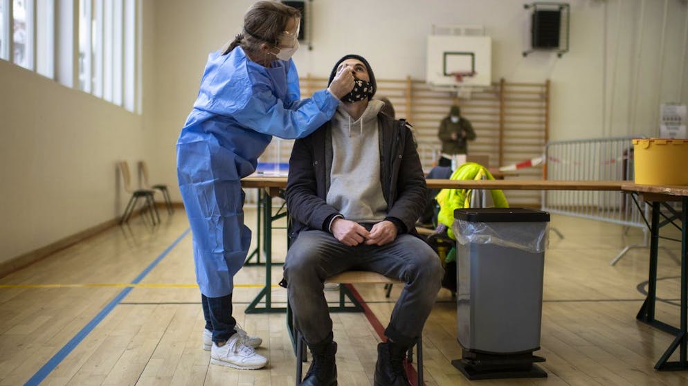 Ein Mann macht einen Schnelltest bei Covid-19 Flaechentests, aufgenommen am Freitag, 11. Dezember 2020, in Zuoz. Der Kanton Graubuenden fuehrt derzeit in drei Regionen freiwillige Flaechentests als Pilotprojekt durch. (KEYSTONE/Gian Ehrenzeller).A man is tested during Covid-19 mass testing, pictured on Friday, December 11, 2020, in Zuoz, Switzerland. Three regions in the canton of Grisons will be mass tested during three days. The test is voluntary. (KEYSTONE/Gian Ehrenzeller)