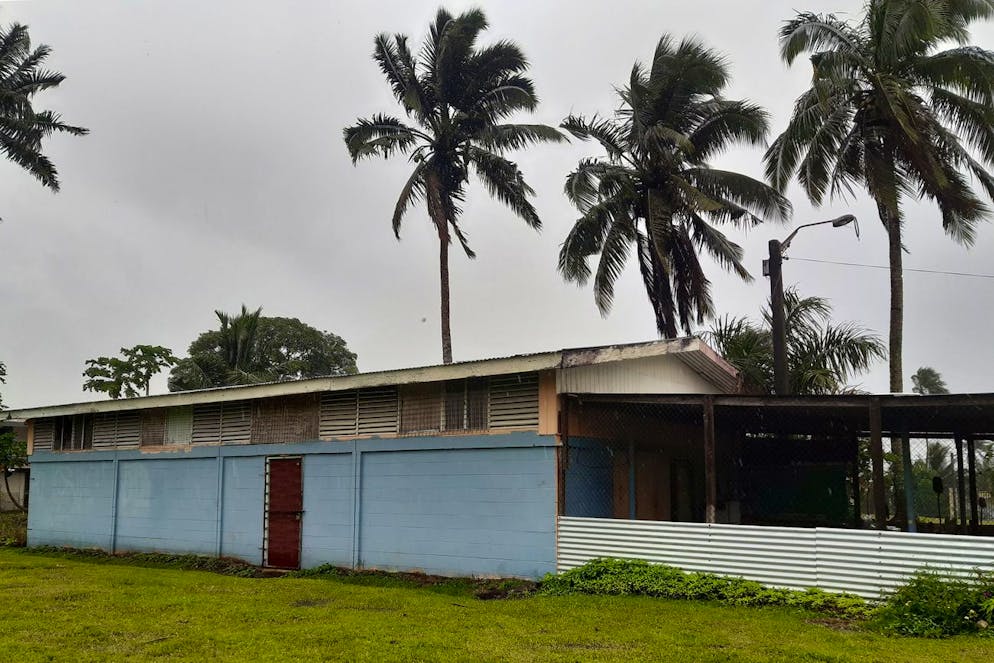 A religious center is shuttered in the preparation for cyclone Yasa in the Tamavua neighborhood of Suva, Fiji, Thursday, Dec. 17, 2020. Fiji was urging people near the coast to move to higher ground Thursday ahead of a nationwide curfew as the island nation prepared for a major cyclone to hit.(AP Photo/Aileen Torres-Bennett)