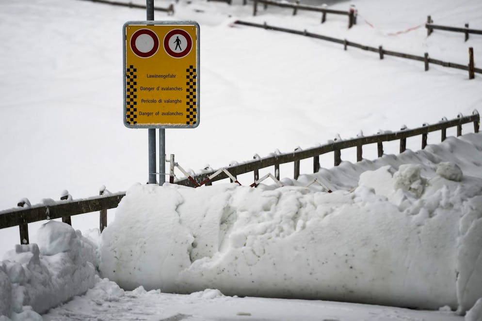 Un panneau indique aux pietons l'interdiction de marcher sur un chemin suite au danger d'avalanches ce lundi 14 janvier 2019 a Wengen dans les Alpes bernoises. Apres les importantes chutes de neige du week-end, le danger d'avalanches est de niveau 4 sur 5 dans la majeure partie des Alpes, selon le dernier bulletin de l'Institut pour l'etude de la neige et des avalanches (SLF). (KEYSTONE/Jean-Christophe Bott)