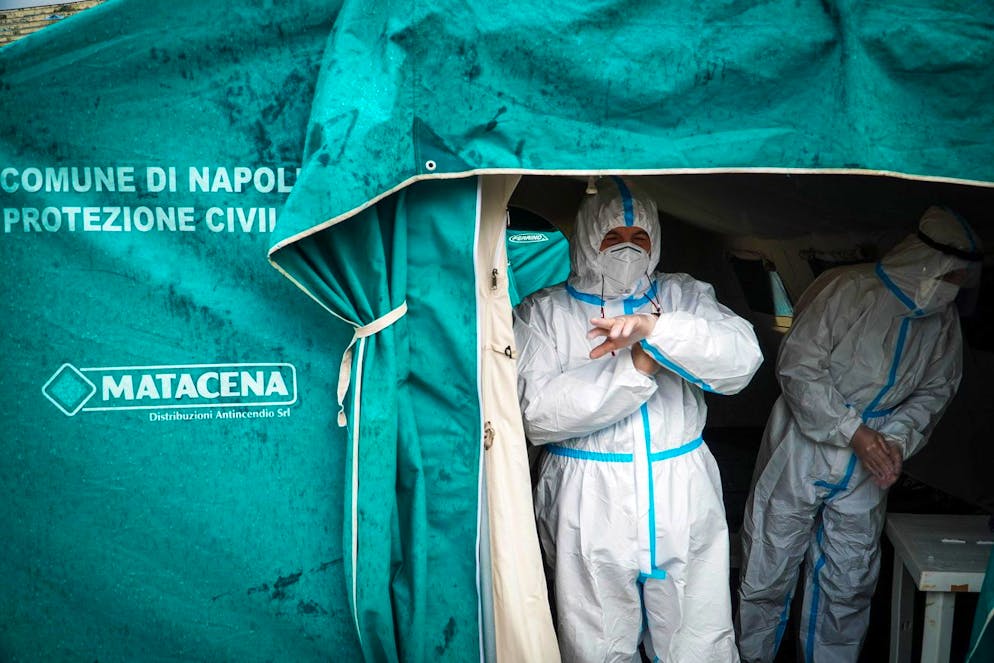 epa08874461 Health professionals carry out rapid anti-covid testing in a bus parking property of ANM (azienda napoletana mobilità ), Naples, Italy, 10 December 2020. EPA/CESARE ABBATE