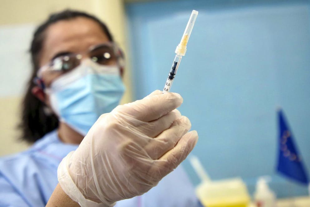 A medical staff member holds a syringe as she prepares to administer the Pfizer-BioNTech COVID-19 vaccine, at the Niguarda hospital in Milan, Italy, Sunday, Dec. 27, 2020. European Union nations officially kicked off a coordinated effort Sunday to give COVID-19 vaccinations to some of the most vulnerable among their nearly 450 million people, marking a moment of hope in the continent's battle against the worst public health crisis in a century. (Matteo Bazzi/Pool via AP)