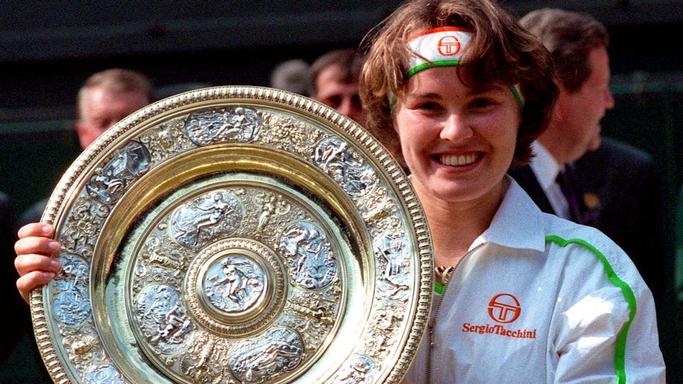 Martina Hingis holds up her trophy, after defeating Jana Novotna in the women's singles final at Wimbledon Center Court on July 5, 1997. Hingis won the final 2-6, 6-3, 6-3, to become in the youngest winner of the championship of this century.  Martina Hingis said on Thursday, November 1, 2007, that she was charged with testing positive for cocaine at Wimbledon and announced her retirement from professional tennis.  Hingis, a five-time Grand Slam champion and former Wimbledon winner, denied using cocaine.  (AP Photo / File / Dave Caulkin)