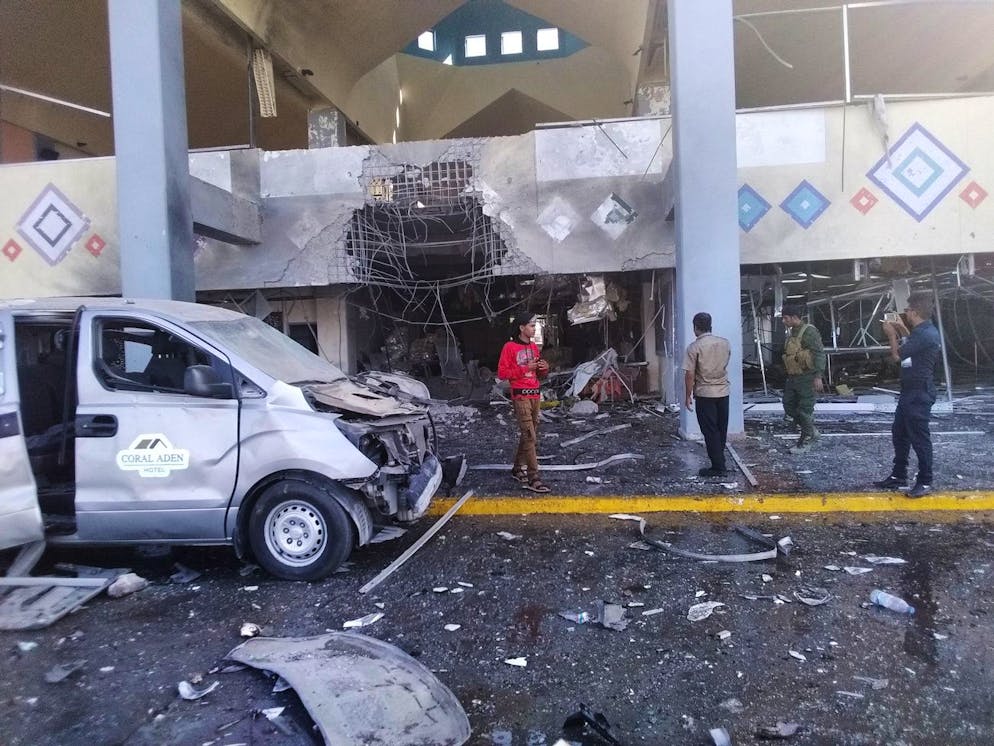 Bystanders and a soldier stand near a damaged portion of the airport of YemenâÄ™s southern city of AdenâÄ™s after an explosion, Wednesday, Dec. 30, 2020. The blast struck the airport building shortly after a plane carrying the newly formed Cabinet landed on Wednesday. No one on the government plane was hurt. (AP Photo/Majid Saleh)