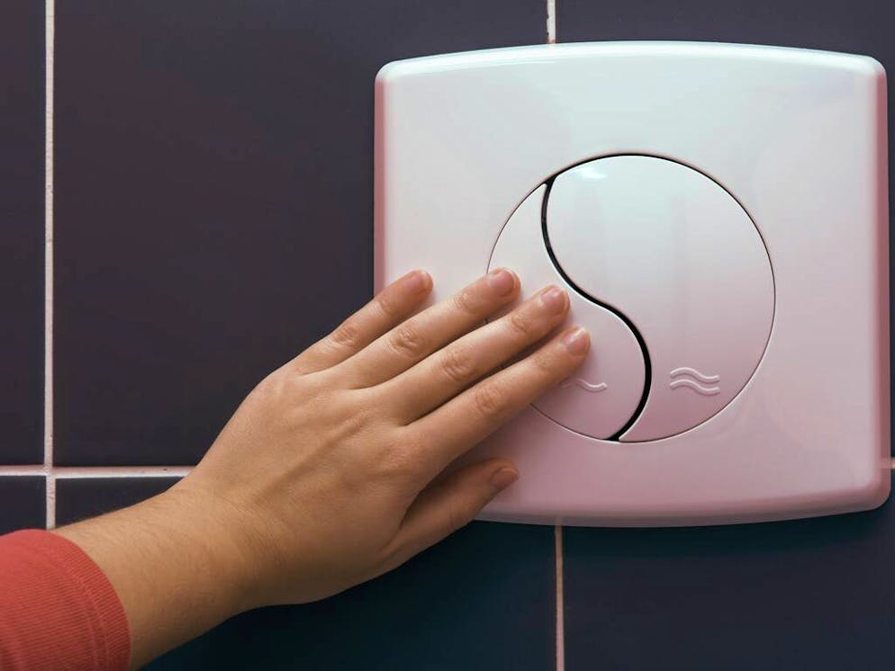 womanÂ´s hand on a water saving toilet device

When: 09 Apr 2010