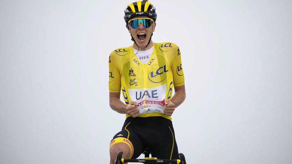 Slovenia's Tadej Pogacar, wearing the overall leader's yellow jersey, celebrates as he crosses the finish line to win the seventeenth stage of the Tour de France cycling race over 178.4 kilometers (110.9 miles) with start in Muret and finish in Saint-Lary-Soulan Col du Portet, France, Wednesday, July 14, 2021. (AP Photo/Christophe Ena)