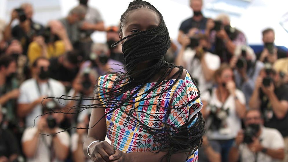 epa09349966 Fatou N'Diaye poses during the photocall for 'OSS 117: Alerte Rouge en Afrique Noire' (OSS 117: From Africa with Love) at the 74th annual Cannes Film Festival, in Cannes, France, 17 July 2021. The movie is presented in the Official Competition of the festival which runs from 06 to 17 July. EPA/IAN LANGSDON