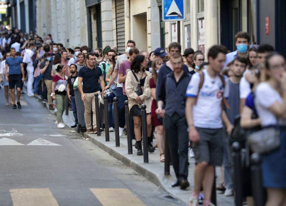 People queue in a street to attend the Kaamelott premiere screening at Grand Rex cinema in Paris, on July 20, 2021. - Kaamelott is directed by French Alexandre Astier and will be released on July 21, 2021. (Photo by GEOFFROY VAN DER HASSELT / AFP) (Photo by GEOFFROY VAN DER HASSELT/AFP via Getty Images)