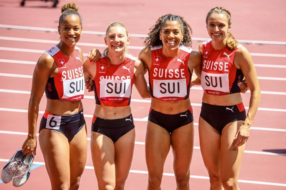 From left, Salome Kora, Ajla Del Ponte, Mujinga Kambundji, and Riccarda Dietsche of Switzerland react after the finish line of the women's athletics 4x100m relay heat at the 2020 Tokyo Summer Olympics in Tokyo, Japan, on Thursday, August 05, 2021. (KEYSTONE/Laurent Gillieron)