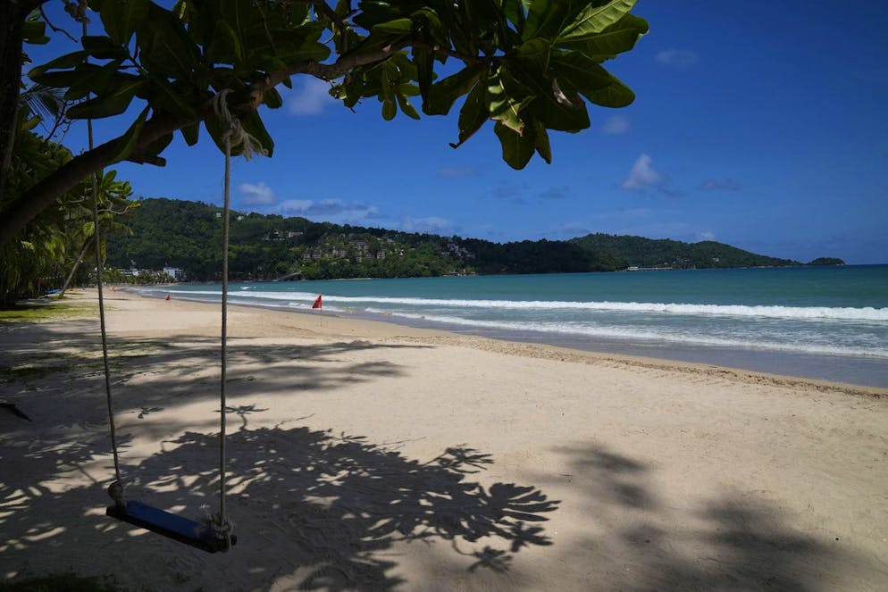 An empty swing hangs from a tree on the empty tourist beach of Patong on Phuket, southern Thailand, Monday, June 28, 2021. Thailand's government will begin the