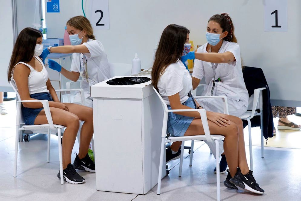 epa09409459 Two teenagers receive doses of a vaccine against COVID-19 at a hospital in Madrid, Spain, 11 August 2021. Madrid begins to vaccinate children over 12 years old, a measure that is already started in other Spanish regions. EPA/CHEMA MOYA