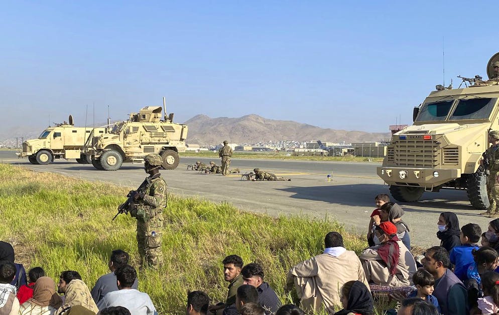 U.S soldiers stand guard along a perimeter at the international airport in Kabul, Afghanistan, Monday, Aug. 16, 2021. On Monday, the U.S. military and officials focus was on Kabul's airport, where thousands of Afghans trapped by the sudden Taliban takeover rushed the tarmac and clung to U.S. military planes deployed to fly out staffers of the U.S. Embassy, which shut down Sunday, and others. (AP Photo/Shekib Rahmani)