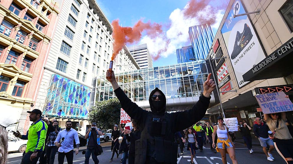 Protesters are seen during an anti-lockdown protest in the central business district of Melbourne, Saturday, August 21, 2021. (AAP Image/James Ross) NO ARCHIVING