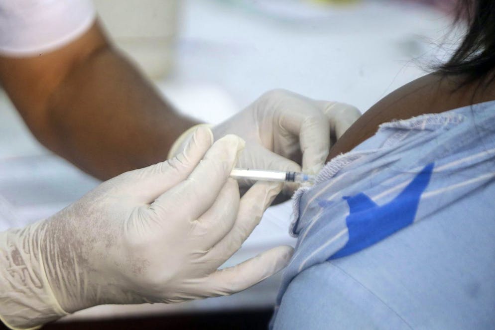 A woman receives the second coronavirus vaccination, the Moderna vaccine, at the health Centre in Lagos, Nigeria Wednesday, Aug 25, 2021. Nigeria has begun the second rollout of COVID-19 vaccines as it aims to protect its population of more than 200 million amid an infection surge in a third wave of the pandemic. (AP Photo/Sunday Alamba)