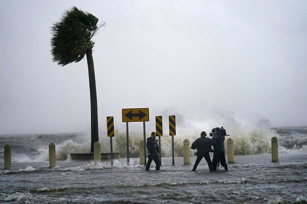 A news crew reports on the edge of Lake Pontchartrain ahead of approaching Hurricane Ida in New Orleans, Sunday, Aug. 29, 2021. (AP Photo/Gerald Herbert)