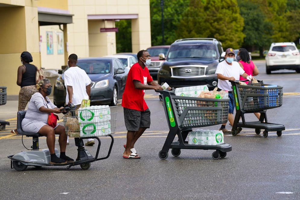 Shoppers stock up on food and water as Hurricane Ida approaches Louisiana, Sunday, Aug. 29, 2021, in Lafayette, La. (AP Photo/David J. Phillip)