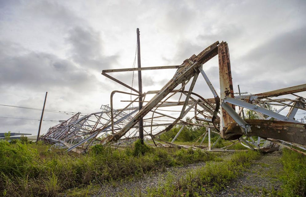 A transmition tower sits on the ground in Bridge City, La., on Monday, Aug. 30, 2021, after it fell during Hurricane Ida Sunday. (David Grunfeld/The Advocate via AP)