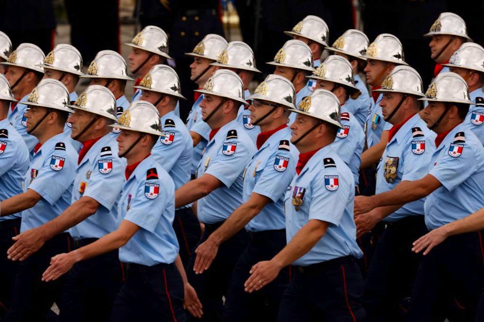 Brigade de sapeurs-pompiers de Paris march during the annual Bastille Day military parade on the Champs-Elysees avenue in Paris on July 14, 2021. (Photo by Ludovic MARIN / AFP) (Photo by LUDOVIC MARIN/AFP via Getty Images)