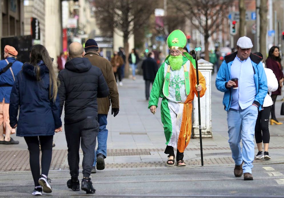 A man dressed as St Patrick walks down O'Connell street in Dublin, Ireland, Wednesday, March, 17, 2021. The St Patrick's Day parades across Ireland were canceled for the second year due to COVID-19 virus. (AP Photo/Peter Morrison)
