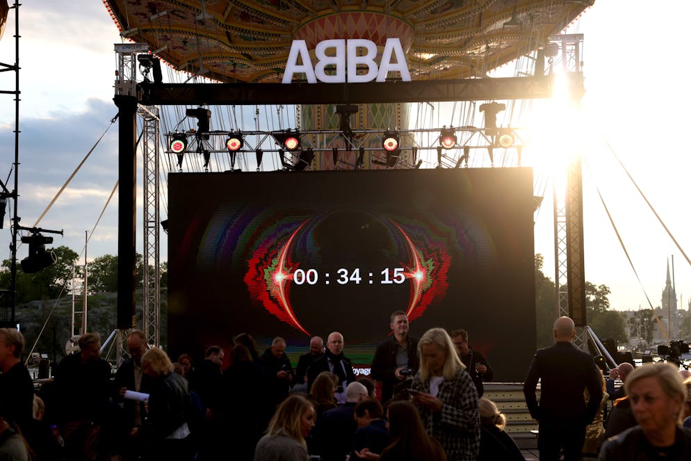 epa09443458 People watch the countdown to the ABBA Voyage event at Grona Lund amusement park in Stockholm, Sweden, 02 September 2021. Abba announced a 'special livestream announcement', the band reported on social media. The announcement is part of their Voyage project, which is still unknown.  EPA/Fredrik Persson SWEDEN OUT