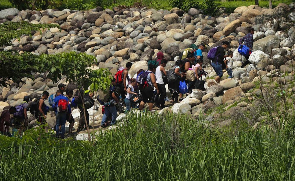 Central American migrants cross into Mexico from Guatemala, near Ciudad Hidalgo, Mexico, Tuesday, June 4, 2019. Mexican police looked on as about half the migrants crossed the Suchiate River on inner-tube rafts. The mainly Honduran migrants then walked into the border city of Ciudad Hidalgo to rest in the main plaza. (AP Photo/Marco Ugarte)