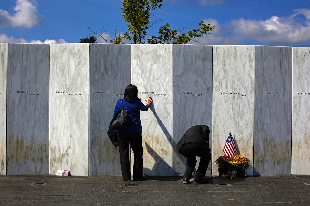 FILE- In this Sept. 11, 2015 file photo, a visitor pauses at the Wall of Names after a Service of Remembrance at the Flight 93 National Memorial in Shanksville, Pa. Victims' relatives and dignitaries will convene Sunday, Sept. 11, 2016, at the site for one of the constants in how America remembers 9/11 after 15 years, the anniversary ceremony itself. (AP Photo/Gene J. Puskar, File)