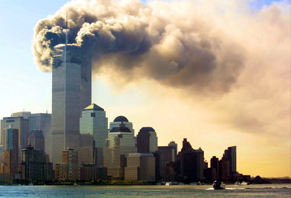 Balls of flames and smoke billow out of the top floors of the World Trade Center Towers September 11, 2001 in New York City, USA. Witnesses say two separate planes flew into the towers, in what is suspected to be a terrorist attack. (KEYSTONE/EPA PHOTO/DPA/Hubert Michael Boesl)