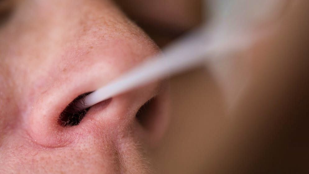 Una persona esegue un autotest dell'antigene del virus Sars-CoV-2 con un tampone nasale a casa.