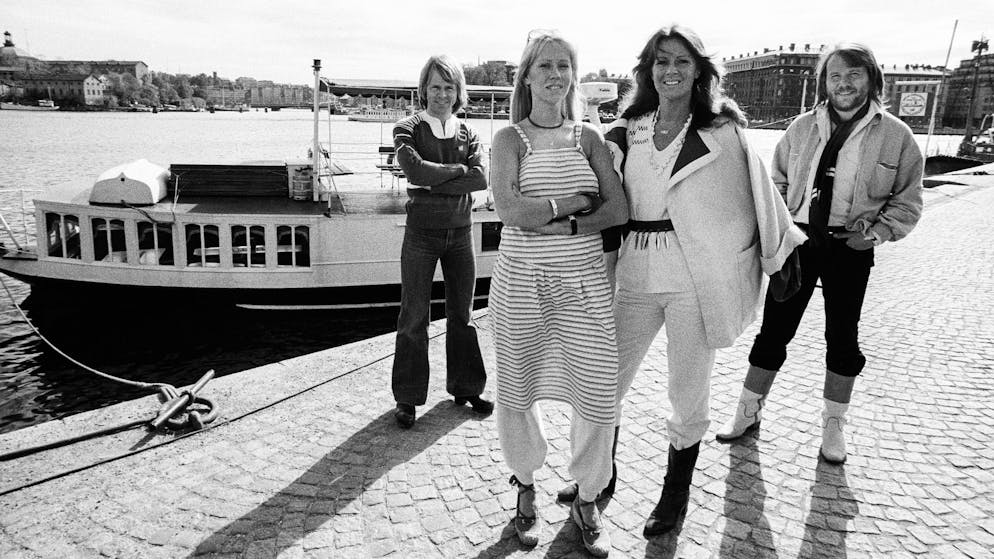 Portrait of Swedish Pop group ABBA as they pose, dockside, in Gamla Stan (Old Town), Stockholm, Sweden, July 1977. Pictured are, from left, Bjorn Ulvaeus, Agnetha Faltskog, Anni-Frid Lyngstad, and Benny Andersson. At the time, Ulvaeus and Faltskog were married while Lyngstad and Andersson were engaged, they married the following year. (Photo by Leif Skoogfors/Getty Images)
