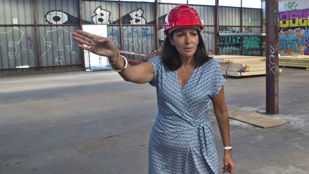 Mayor of Paris Anne Hidalgo gestures as she visits the construction site of a new reception center for migrants , Monday, Sept. 12, 2016. A new reception center for migrants in the French capital, is scheduled to open next month, in an unusual and controversial effort to cope with Europe's migrant crisis. (AP Photo/Michel Euler)