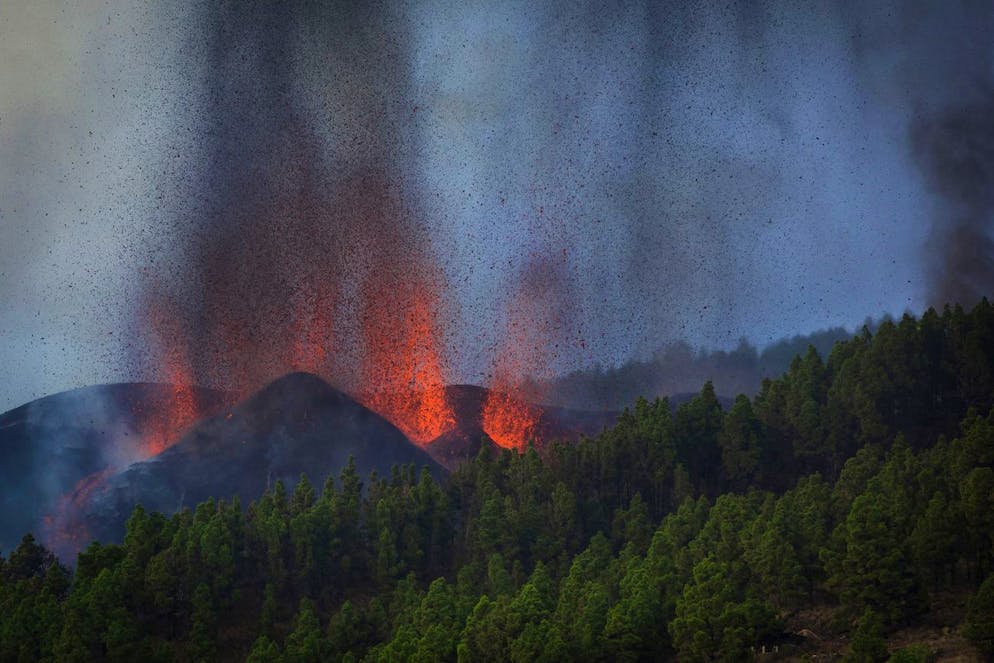Lava flows from an eruption of a volcano at the island of La Palma in the Canaries, Spain, Sunday, Sept. 19, 2021. A volcano on Spain's Atlantic Ocean island of La Palma erupted Sunday after a weeklong buildup of seismic activity, prompting authorities to evacuate thousands as lava flows destroyed isolated houses and threatened to reach the coast. New eruptions continued into the night. (AP Photo/Jonathan Rodriguez)