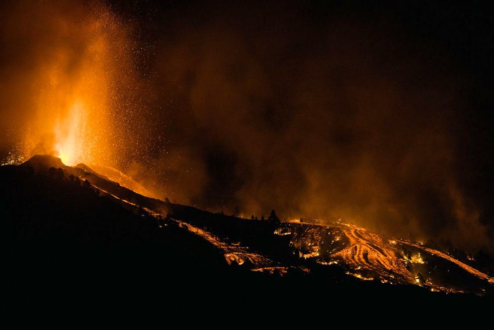Lava flows from an eruption of a volcano at the island of La Palma in the Canaries, Spain, Sunday, Sept. 19, 2021. A volcano on Spain's Atlantic Ocean island of La Palma erupted Sunday after a weeklong buildup of seismic activity, prompting authorities to evacuate thousands as lava flows destroyed isolated houses and threatened to reach the coast. New eruptions continued into the night. (AP Photo/Jonathan Rodriguez)