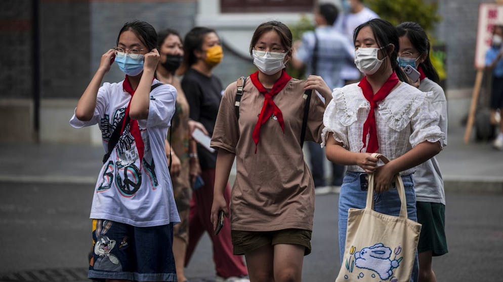 epa09429999 School girls wearing red scarfs representing Young Pioneers of China walk on the street in Shanghai, China, 26 August 2021. 'Xi Jinping Thought on Socialism with Chinese Characteristics for a New Era,' the political ideology of the Chinese President will be integrated into the national curriculum from primary school up to university. The goal is to help the country's youth to 'establish Marxist belief,' 'cultivate their hard-working spirit,' and education on national security, the Chinese Ministry of Education reported in a document published on 24 August 2021. EPA/ALEX PLAVEVSKI