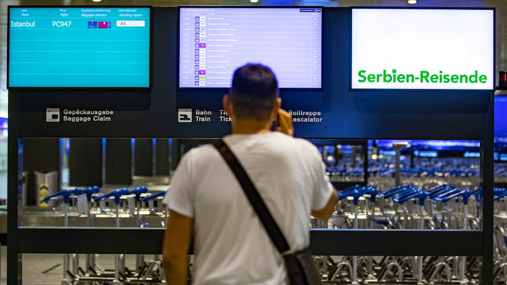 Ein am Flughafen Zürich gelandeter Passagier informiert sich über die Einreisebestimmungen. (Symbolbild)