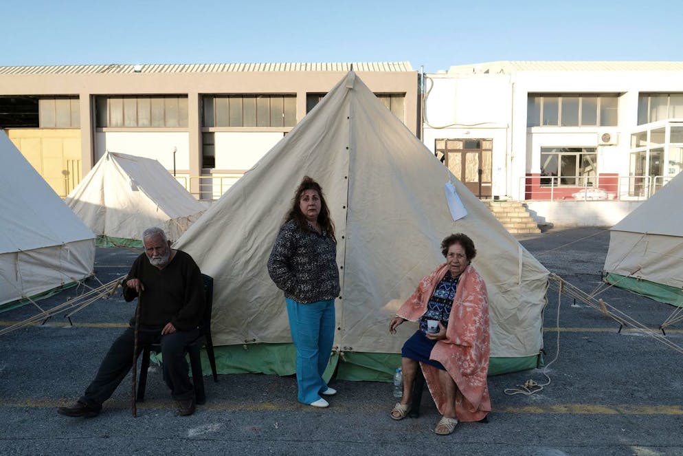 Des habitants se tiennent devant leurs tentes dans le village d'Arkalochori sur l'île méridionale de Crète, en Grèce, le mardi 28 septembre 2021. Les autorités ont installé des tentes et mobilisé des dizaines de chambres d'hôtels pour abriter les centaines de personnes dont les maisons ont été jugées trop dangereuses pour retourner s'y installer.