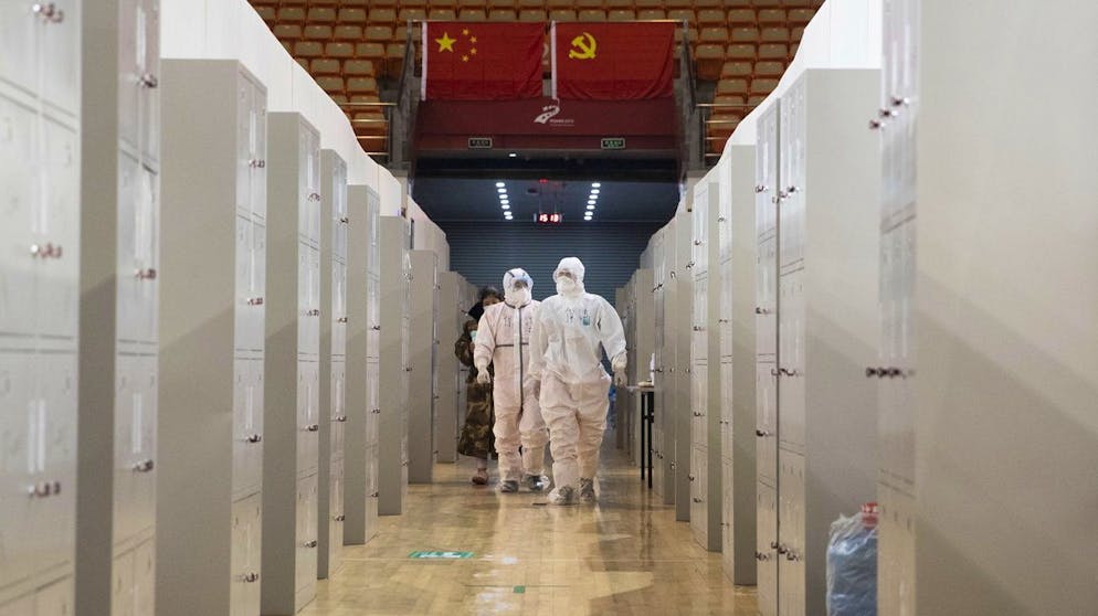 epa08217777 Medical staff carry out checks on patients in Wuhan Fangcang hospital, a makeshift hospital to treat Covid-19 patients in Wuhan City, Hubei Province, China, 14 February 2020. The disease caused by the novel coronavirus (SARS-CoV-2) has been officially named COVID-19 by the World Health Organization (WHO). The Chinese government said 14 February that a total of 1,716 health care workers had been infected with the disease, a number much greater than those recorded during the 2003 Sars outbreak. EPA/STRINGER CHINA OUT