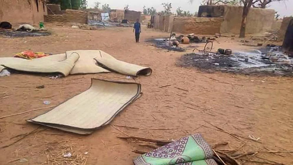 epa08918741 A boy from Niger walks in the village of Tchombangou following a deadly attack which killed seventy villagers in Tchombangou in Niger's Tillabéri region, Niger 03 January 2021 (issued 04 January 2021). According to Niger's prime minister Brigi Rafini one hundred have been killed in villages in Niger's Tillabéri region following simultaneous attacks on the villages of Tchombangou and Zaroumdareye near the border with Mali. No group has claimed responsibility for the attacks. EPA/STR BEST QUALITY AVAILABLE