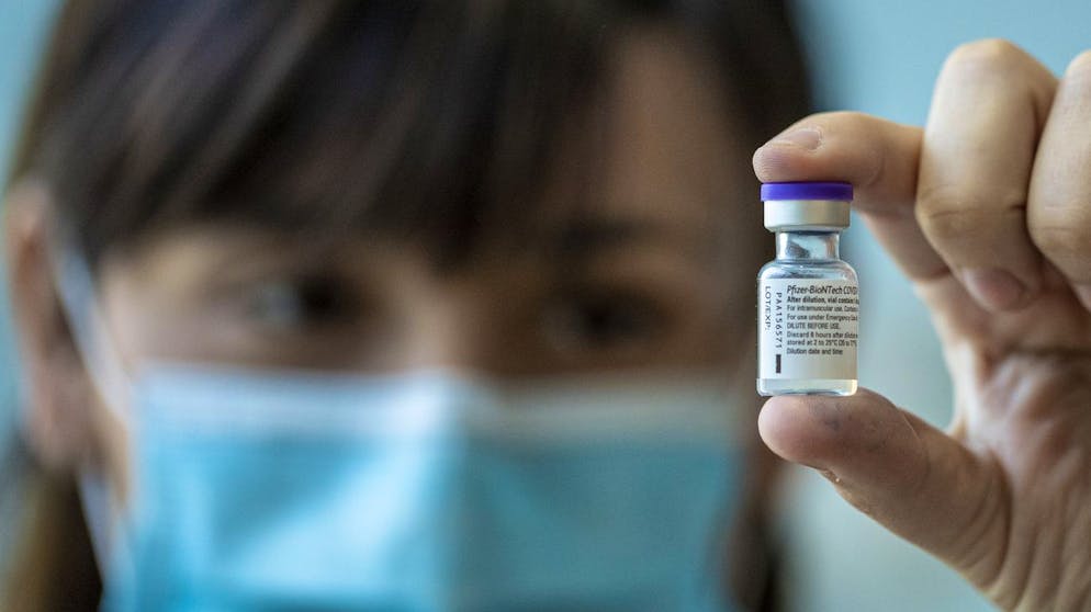 A medical worker shows a vial of the Pfizer-BioNTech COVID-19 vaccine while applying a second dose to health workers at Posta Central Hospital in Santiago, Chile, Friday, Jan. 15, 2021. (AP Photo/Esteban Felix)