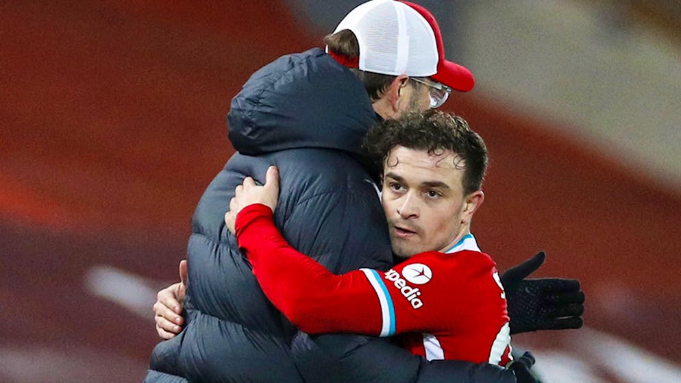 Liverpool's Xherdan Shaqiri hugs Liverpool's manager Jurgen Klopp after being substituted during the English Premier League soccer match between Liverpool and Manchester United at Anfield Stadium, Liverpool, England, Sunday, Jan. 17, 2021. (Phil Noble/Pool via AP)