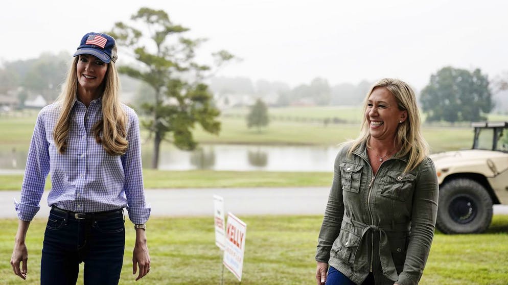 Sen. Kelly Loeffler, R-Ga., left, and Republican congressional candidate Marjorie Taylor Greene, right, arrive a news conference on Thursday, Oct. 15, 2020, in Dallas, Ga. (AP Photo/Brynn Anderson)