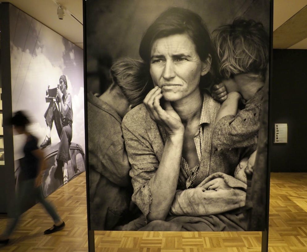 epa06122155 A visitor walks past US documentary photographer and photojournalist Dorothea Lange's famous portrait of 'Migrant Mother' Nipomo, California, 1936, while Lange was employed by the US government's Farm Security Administration (FSA) program, formed during the Great Depression, is displayed at the Oakland Museum of California, in Oakland, California, USA, 02 August 2017. The Museum received Lange's personal collection as a gift in 1966, a year after her death. EPA/JOHN G. MABANGLO