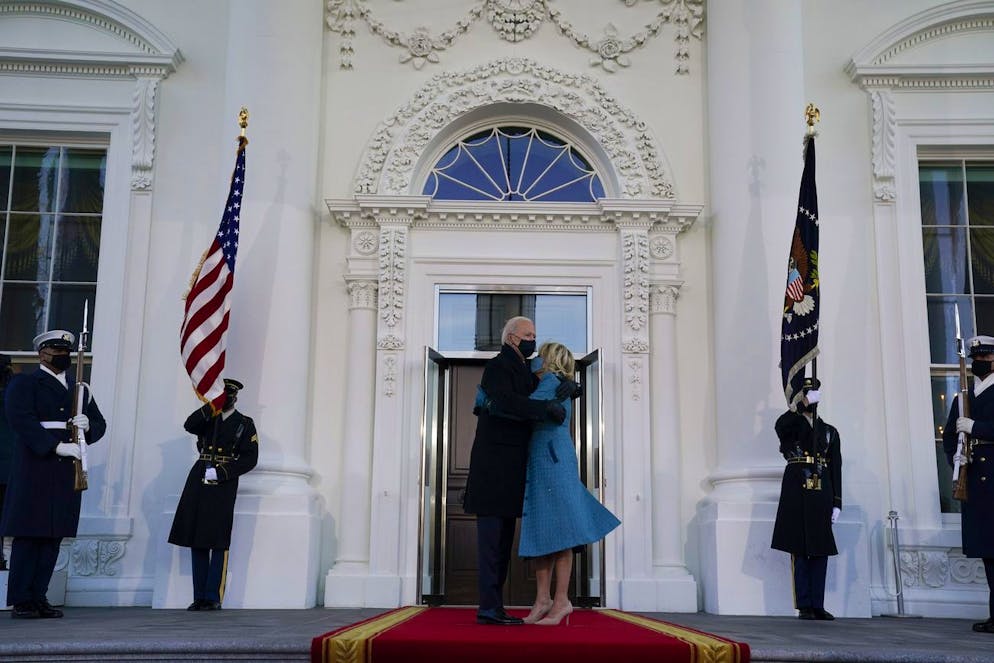 President Joe Biden hugs first lady Jill Biden as they prepare to walk into the White House, Wednesday, Jan. 20, 2021, in Washington, after being sworn in as the 46th president of the United States. (AP Photo/Evan Vucci)